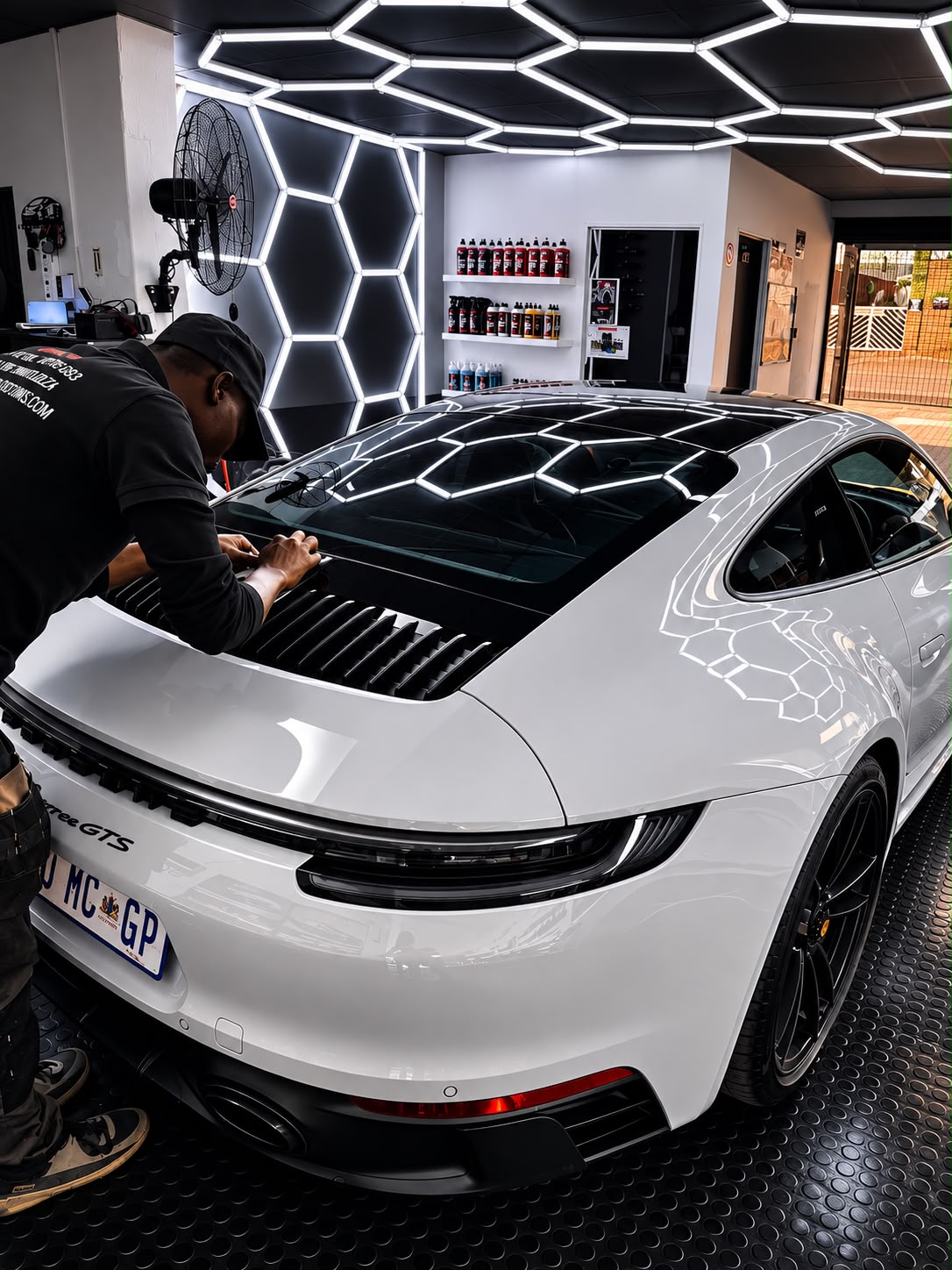Shift and Co Customs vinyl wrap installer working on a Porsche 911 GTS